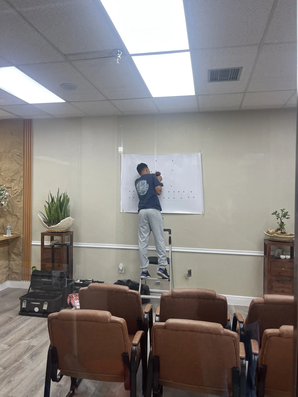 Installer templating the wall sign